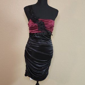 One shoulder cocktail dress, burgundy and black, floral accents.